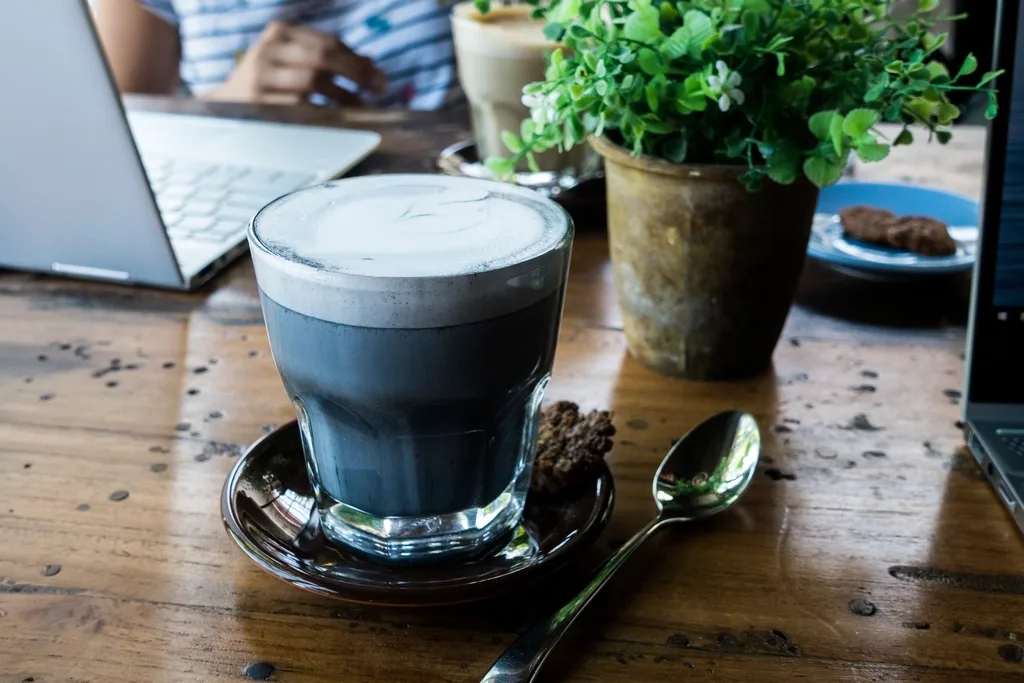 Cappuccino in a cup on a wooden table, shot close up like a menu product photo