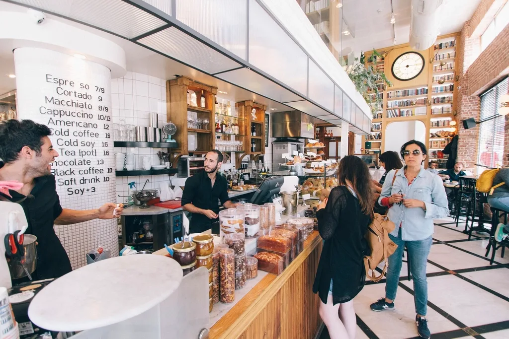 Customers at the counter of a small local cafe