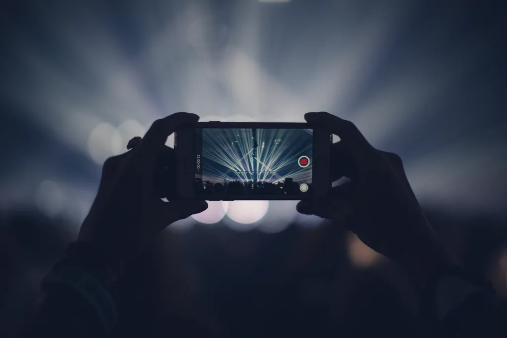 A phone on a stand recording a short video, the setup used for filming reels